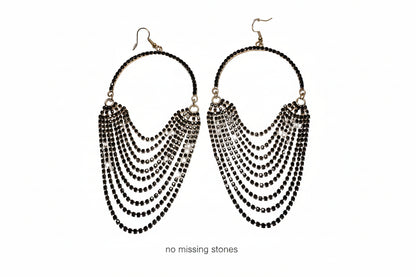 Women’s gold jewelry – black and gold chandelier earrings with layered drops and tiny stones.